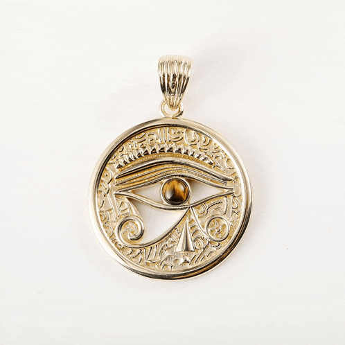 a gold pendant with an eye on it