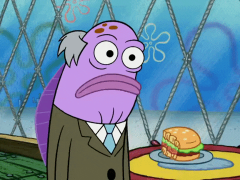 a cartoon character with a hamburger on a plate in front of him