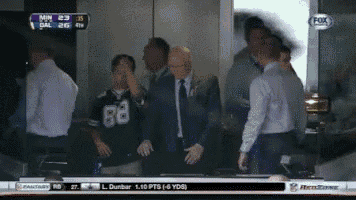 a group of men are watching a football game on a fox channel