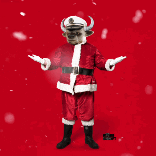 a bull dressed as santa claus is holding up a sign that says yo ho ho