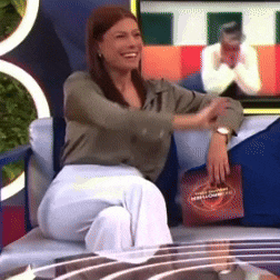 a woman is sitting on a couch holding a bag that says ' marshmallows '