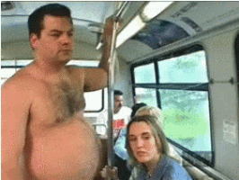a shirtless man is holding onto a railing on a bus while a woman looks on