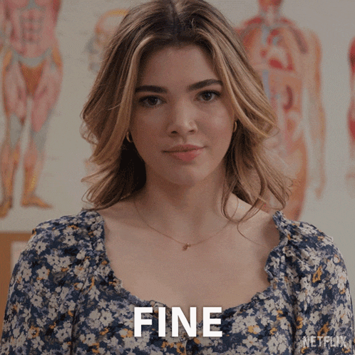 a woman in a blue floral dress says fine in front of a netflix poster