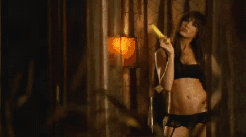 a woman in lingerie is holding a banana and looking out a window