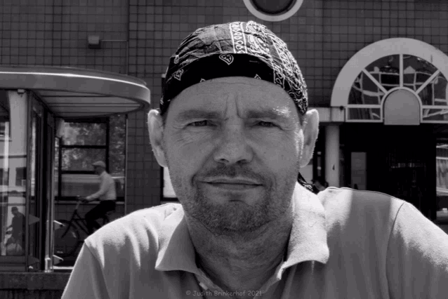 a black and white photo of a man wearing a bandana taken by justin brewerhof