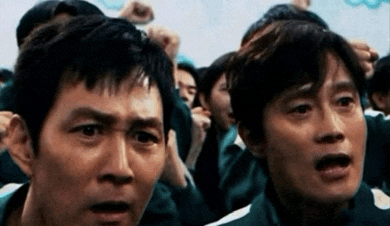 two men are standing next to each other in a crowd of people .