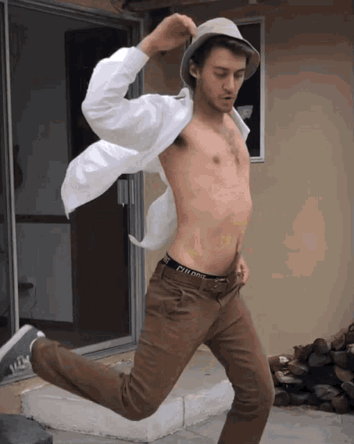a shirtless man wears a hat and a pair of underwear that says ' clifford ' on it