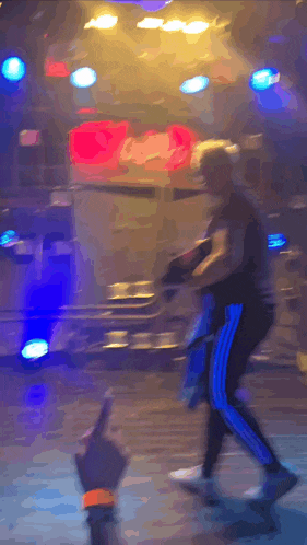 a blurry picture of a person dancing in a dark room