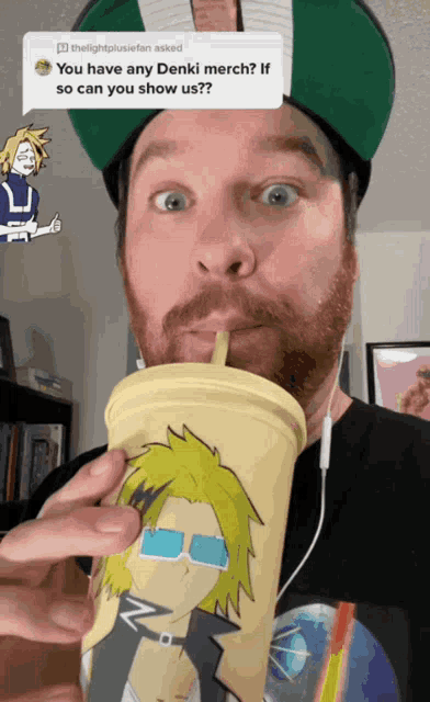 a man is drinking from a cup with a denki merch on the side