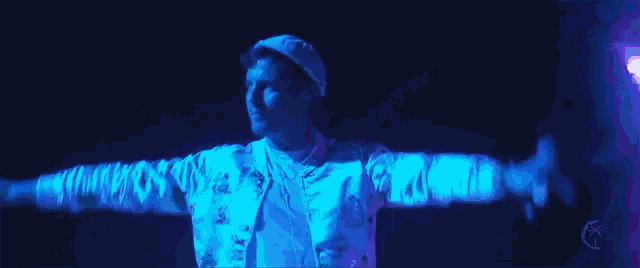 a man with his arms outstretched is wearing a white hat and a white shirt