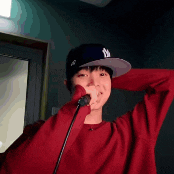 a person wearing a ny hat and a red sweater