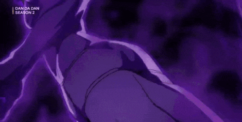 a close up of a person 's hand with purple nails on a dark background .