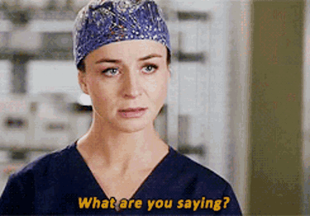 a woman wearing scrubs and a hat says " what are you saying "
