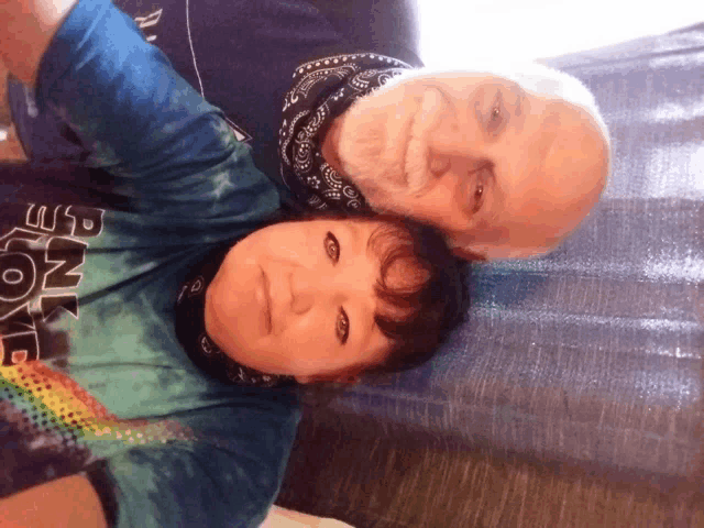 a man and a woman are posing for a picture and the woman is wearing a shirt that says ' planet love '
