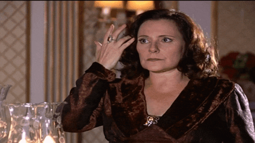 a woman wearing a ring on her finger is looking at something