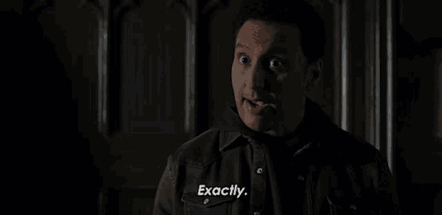 a man in a brown jacket is making a funny face and saying exactly .