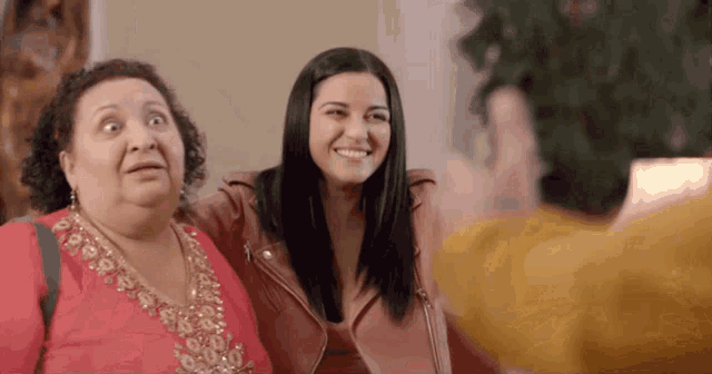 two women are posing for a picture and one of them is making a face