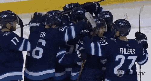 a group of hockey players including ehlers and number 27
