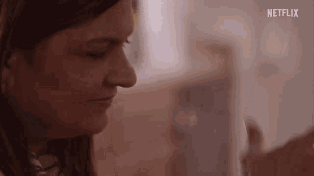 a close up of a woman 's face with netflix written on the bottom of the screen .