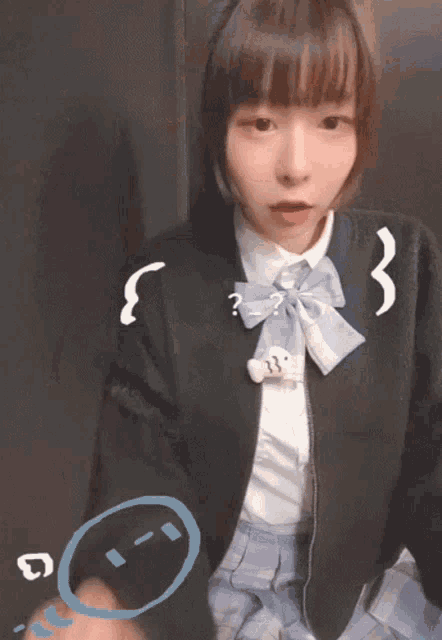 a girl wearing a black jacket with a blue bow and a question mark on her neck