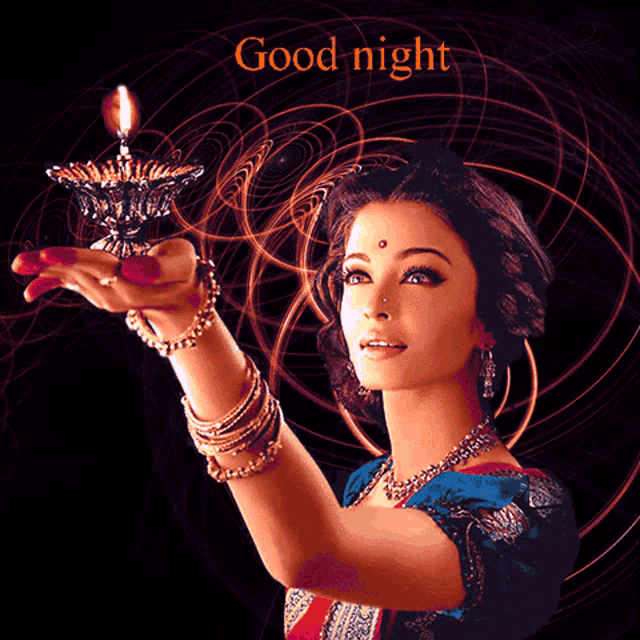 a woman is holding a candle in her hand and the words good night are above her