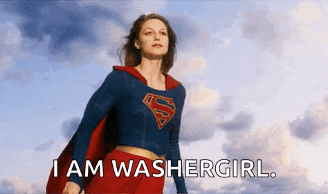 a woman in a superman costume is standing in front of a cloudy sky with the words `` i am washergirl '' .