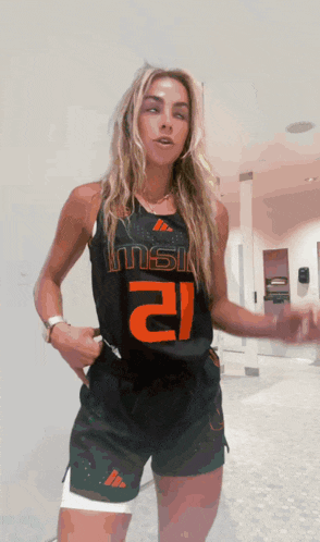 a woman is wearing a black tank top with the number 2 on it
