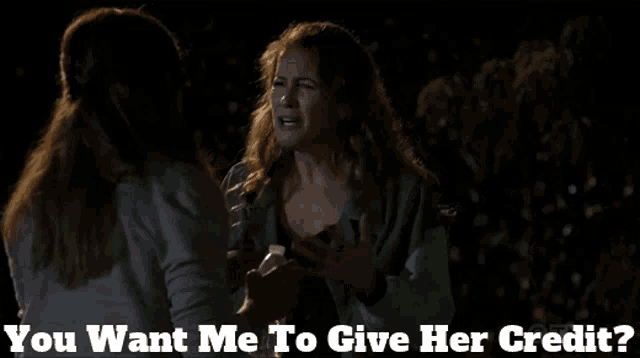 two women talking with the words you want me to give her credit below them