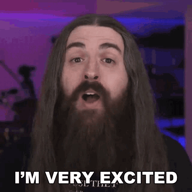 a man with long hair and a beard is very excited