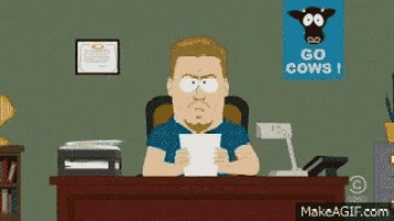 a man is sitting at a desk with a sign that says go cows