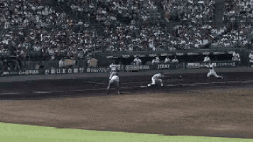 a baseball game is being played in a stadium with a crowd watching .