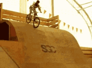 a person is riding a bike on a ramp that says ssc