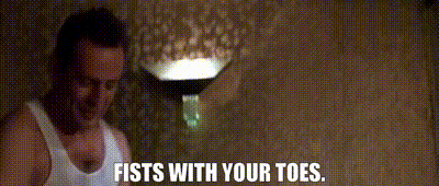 a man in a white tank top is saying fists with your toes
