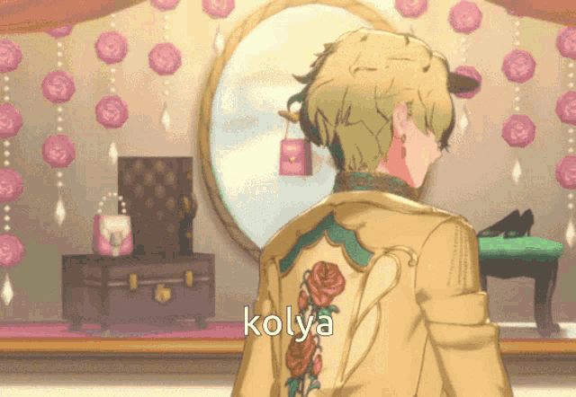 a man in a yellow jacket with kolya written on the back stands in front of a mirror
