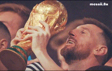 a man with a beard is holding a trophy in his hands in front of a crowd .