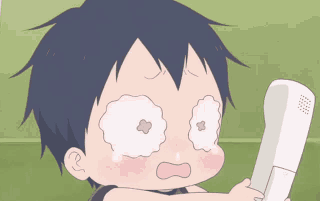a little boy is crying while holding a phone
