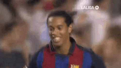 a close up of a soccer player smiling while playing a game .
