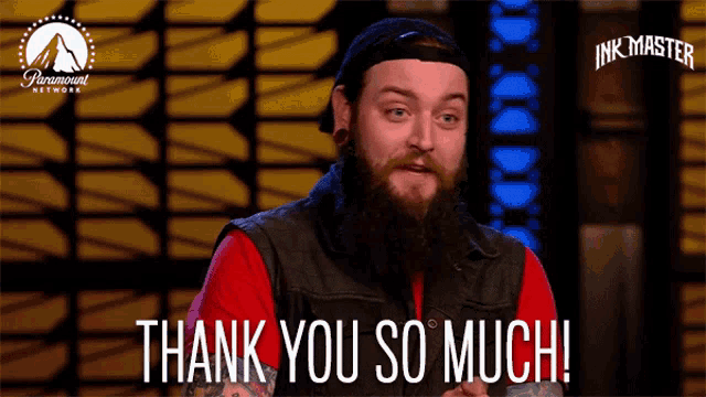 a man with a beard is giving a thank you so much sign