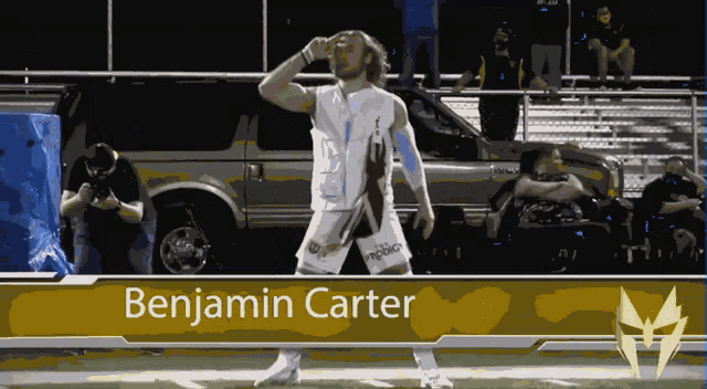 a football player named benjamin carter stands on a field