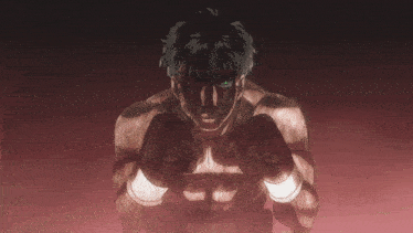 a man with green eyes is wearing boxing gloves and looking at the camera
