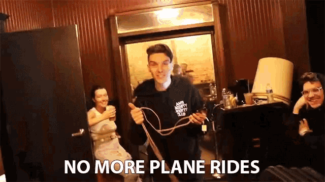 a man holding a rope in a room with the words no more plane rides above him