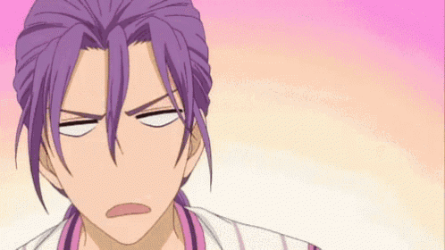 a close up of a person with purple hair making a face .