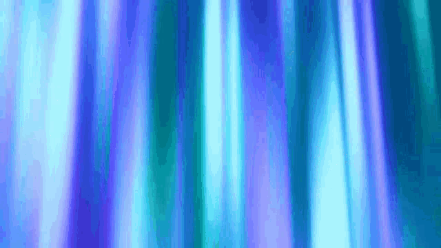 a close up of a blue and purple curtain with a blurred background