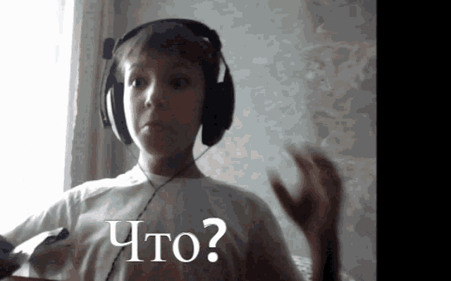a young boy wearing headphones and a shirt that says " что " on it