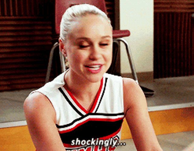 a cheerleader with the word shockingly written on her chest