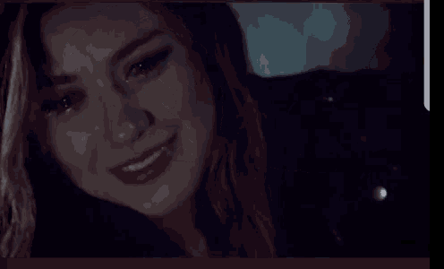 a close up of a woman 's face with tears coming down her face .