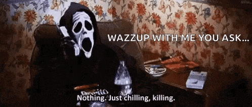 a ghostface is sitting on a couch talking on a cell phone .