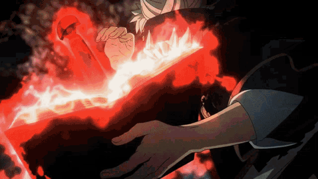 a person in a black shirt is holding a red object in their hand