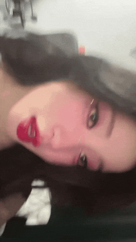 a blurry picture of a woman with red lipstick on her lips