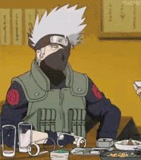 a man in a mask is sitting at a table